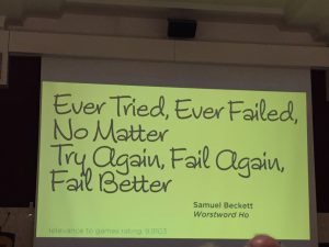 A yellow slide projected on the screen reads "Ever Tried, Ever Failed, No Matter. Tray Again, Fail Again, Fail Better. Samuel Becket Worstword HO.